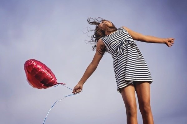a girl holding a balloon