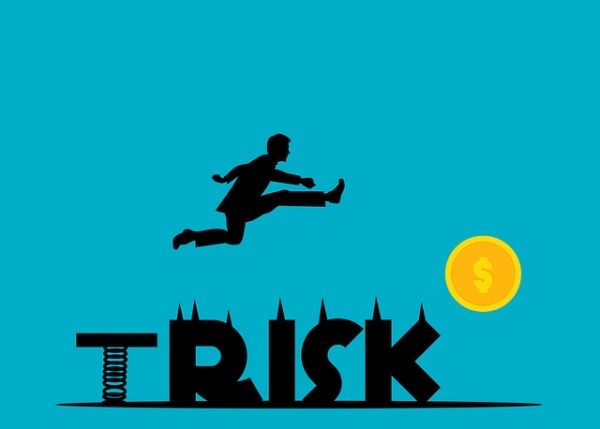 a person jumping over the word 'risk'