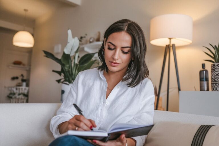 a woman writing in her journal