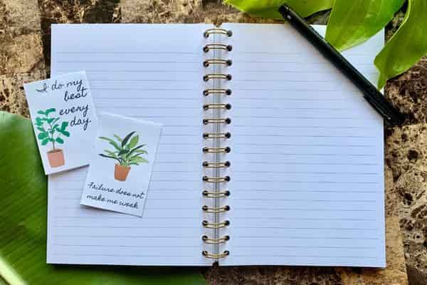 plant themed affirmation cards on a journal