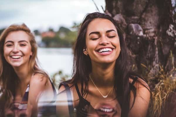two women laughing and smiling
