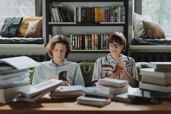 Man and Woman Reading Books together