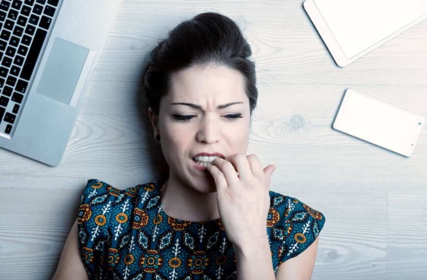 a teacher nervously biting her nails