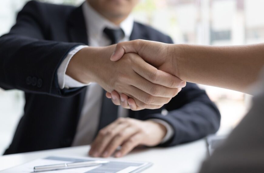 two people shaking hands at a job interview