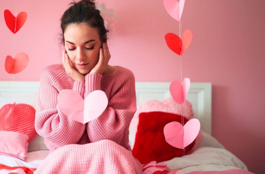 a woman looking down at a heart during the month of february