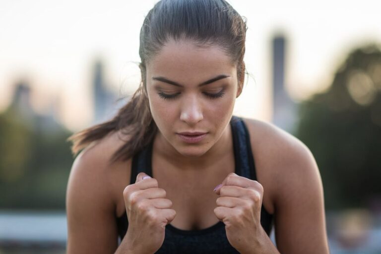 a young woman focusing on overcoming a challenging exercise